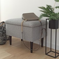 Szara tapicerowana ławka ze schowkiem.