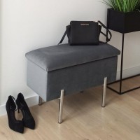 Skrzynia tapicerowana w kolorze szarym.